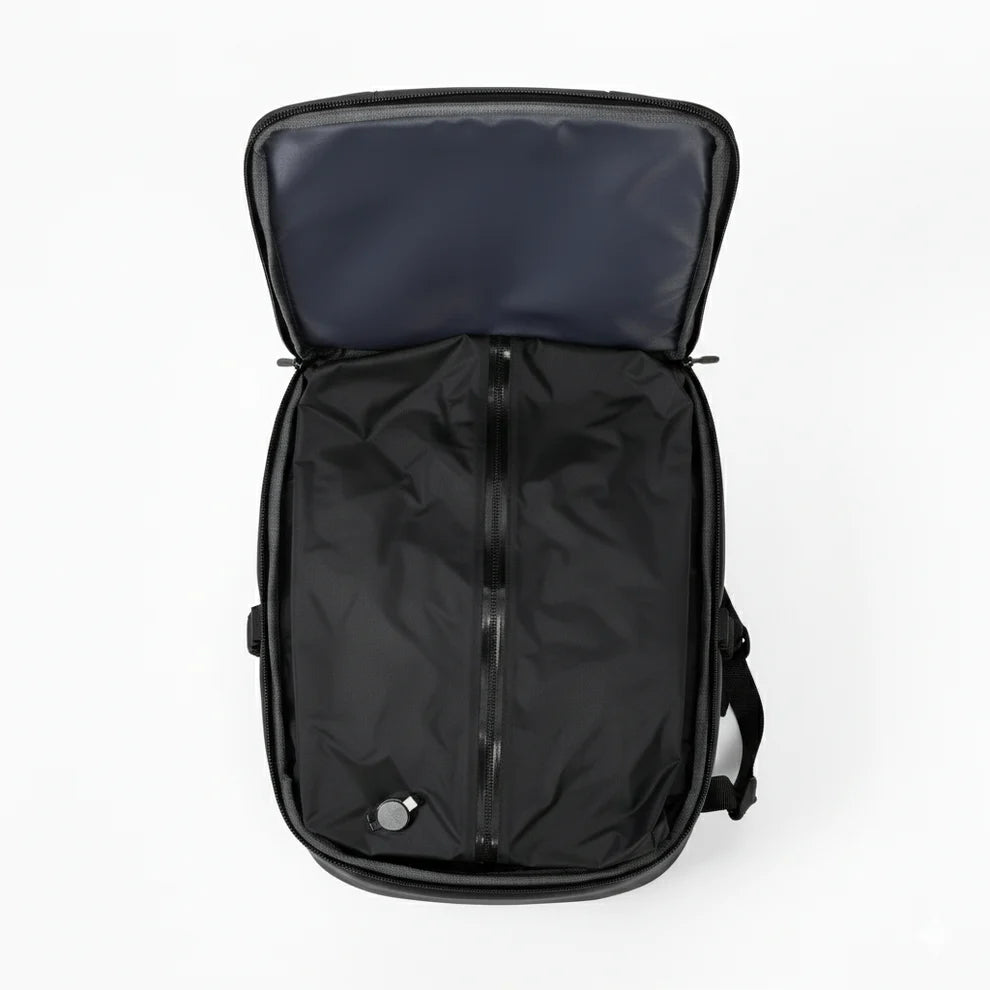 Black backpack with open lid on a white background